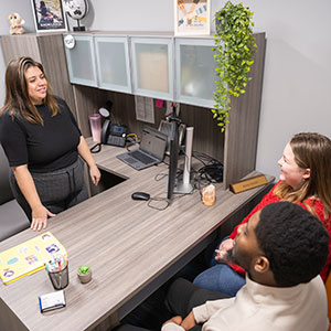 Kelsey Guerard speaks with students in her office in SUNY Canton’s Dana Hall.