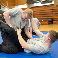 Two cadets practice defense skills during the Police Academy.