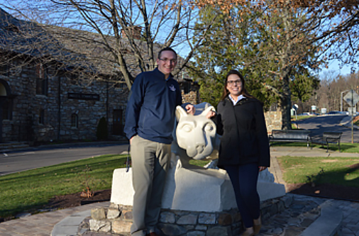 Penn State – Hazelton Director of Athletics Ryan Ehrie and intern Aimee Craig pose with the Penn State Nittany Lion on campus.