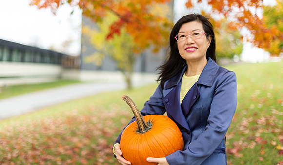 Eunjyu Yu holding a pumpkin.