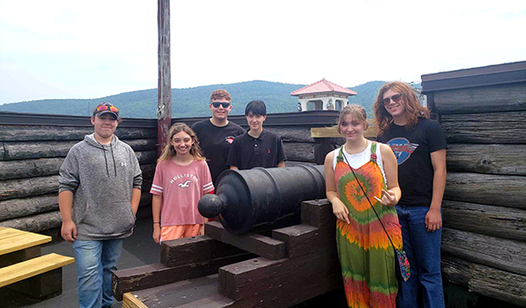 Liberty Partnership students standing next to a cannon in Fort William Henry.