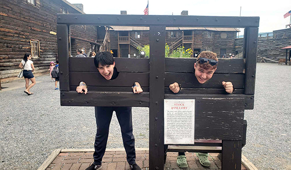Two Liberty students pretend to be in the gallows at Fort William Henry.