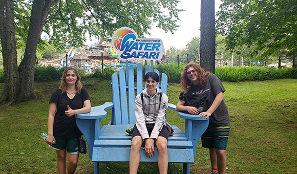 Liberty students pose around a large blue Adirondack chair at Water Safari.
