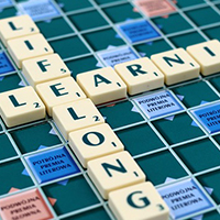 Lifelong Learning spelled out on a Scrabble board.