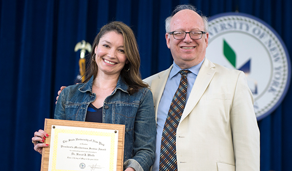 SUNY Canton faculty member Barat Wolfe receives the Meritorious Service Award from President Zvi Szafran