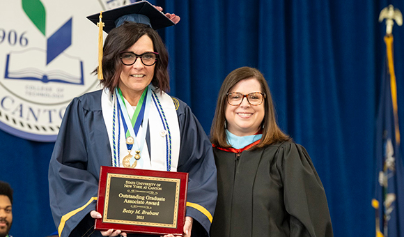 Betsy Brabart is presented with the Outstanding Graduate Associate Degree Award by Vice President Courtney Bish.