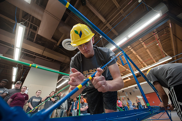 A Mechanical Engineering Technology major tightens a bolt on SUNY Canton's steel bridge.