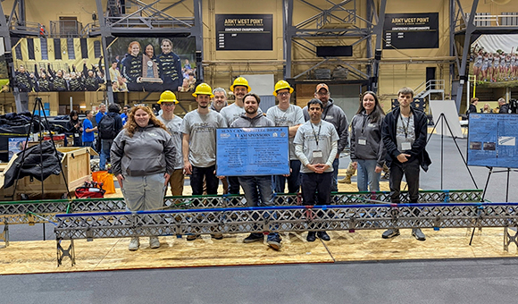 SUNY Canton's 2025 Steel Bridge Team poses with their bridge at West Point.