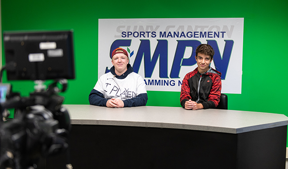 Two CFES students demo a sports broadcast in the Sports Management studio.