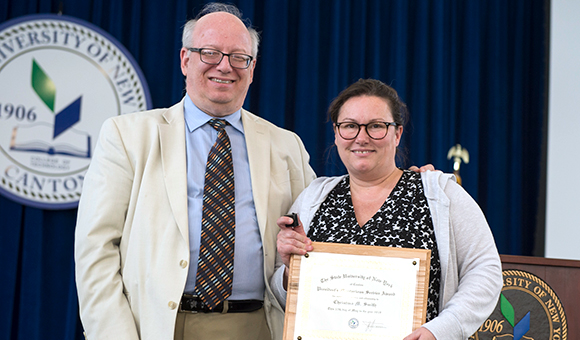 SUNY Canton President Zvi Szafran presents Christina Smith with the Meritorious Service Award