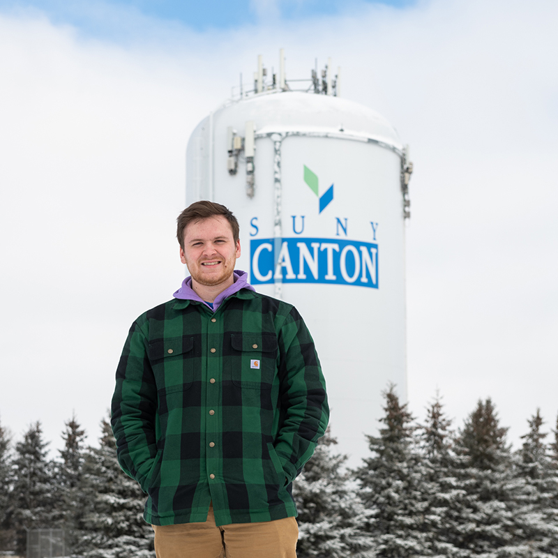 Christopher Gilman in front of SUNY Canton water tower.