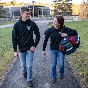 Gage Halavin and Alivia Gilson walk to the Richard W. Miller Campus Center with their EMS gear.