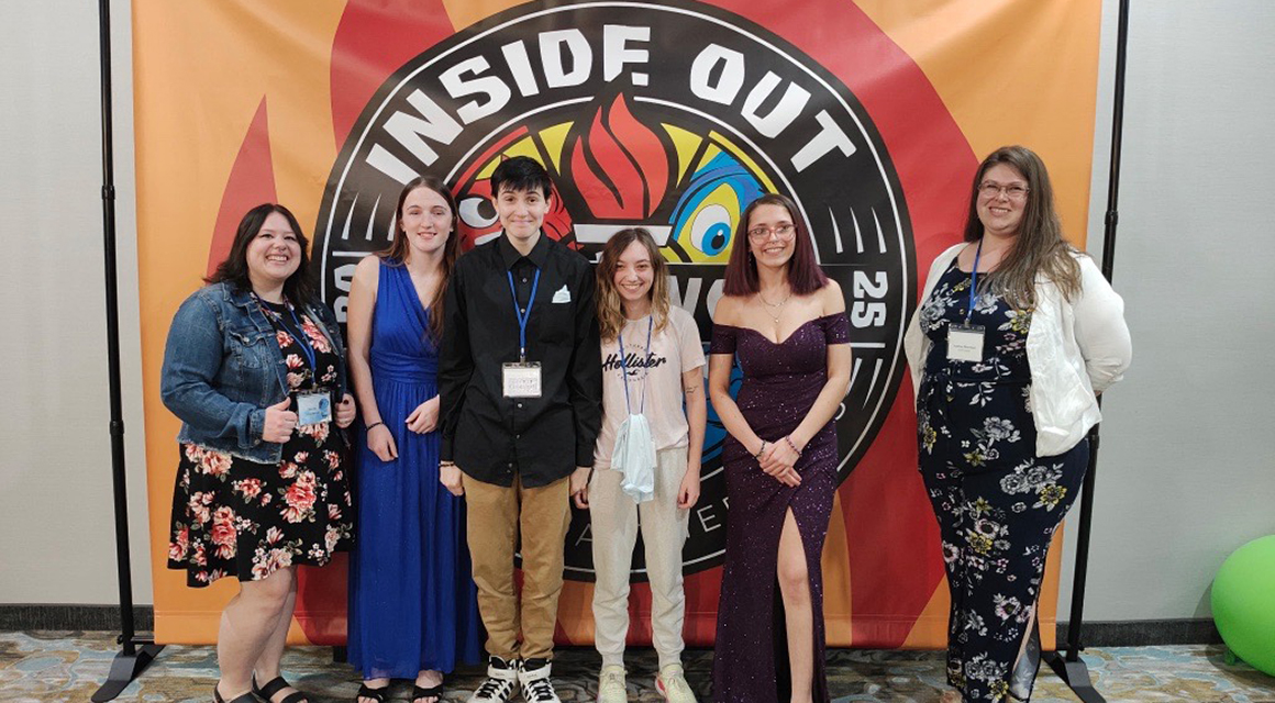 Students in formal attire pose at the Empire Promise Youth Summit.