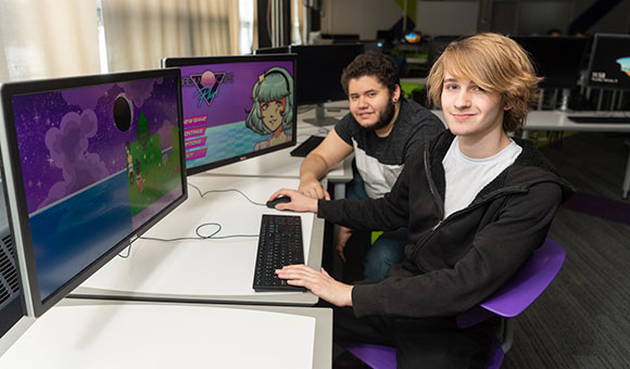 Zachary Samalot and Paul Riggio demonstrate their new video games in Nevaldine Hall’s Digital Studio.