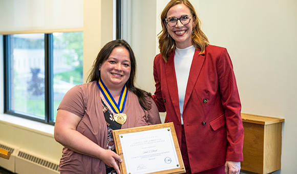Janet Parcell is awarded the Chancellor's Award by Vice President Lenore VanderZee.