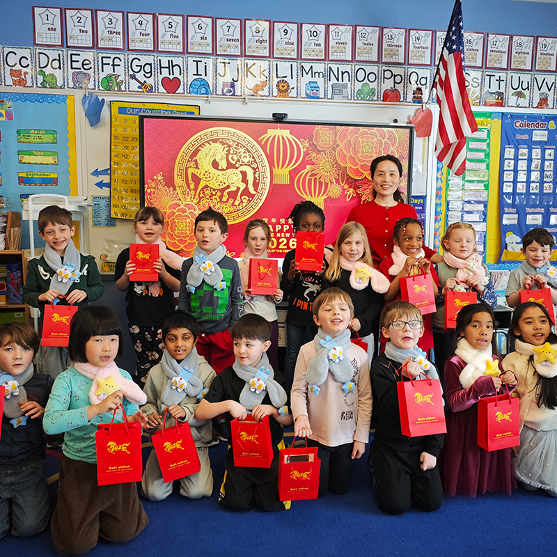 Visiting Assistant Professor Alice Jiang poses with first and third graders from Potsdam Central School.