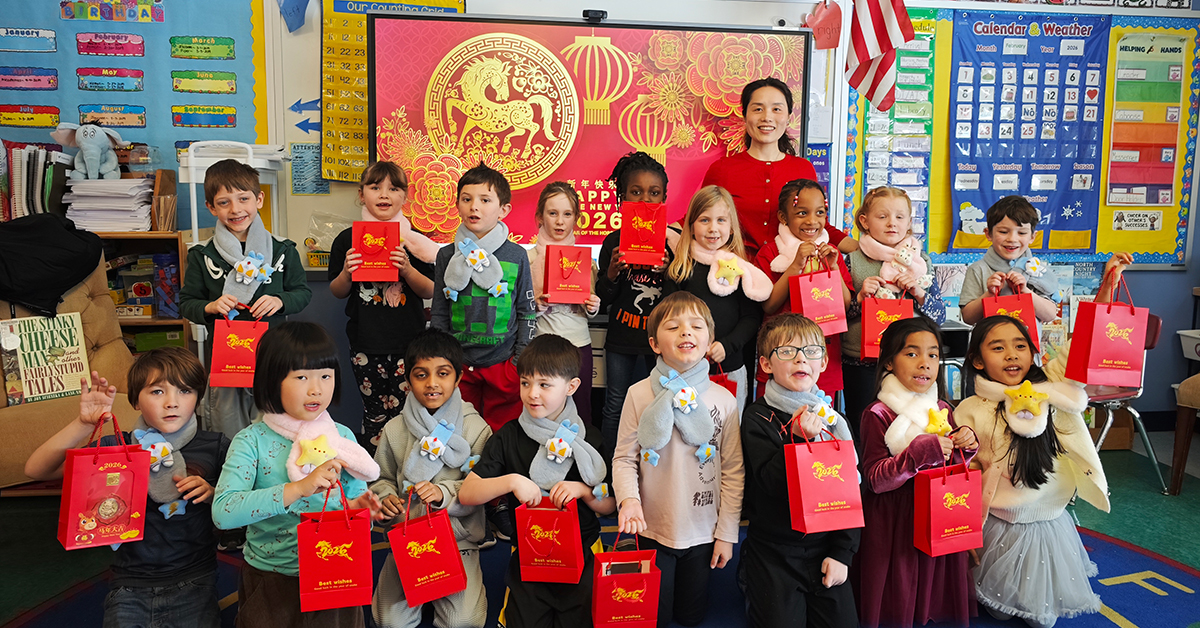 Visiting Assistant Professor Alice Jiang poses with first and third graders from Potsdam Central School.