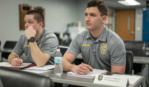 Joseph Mastro takes notes during academy courses.