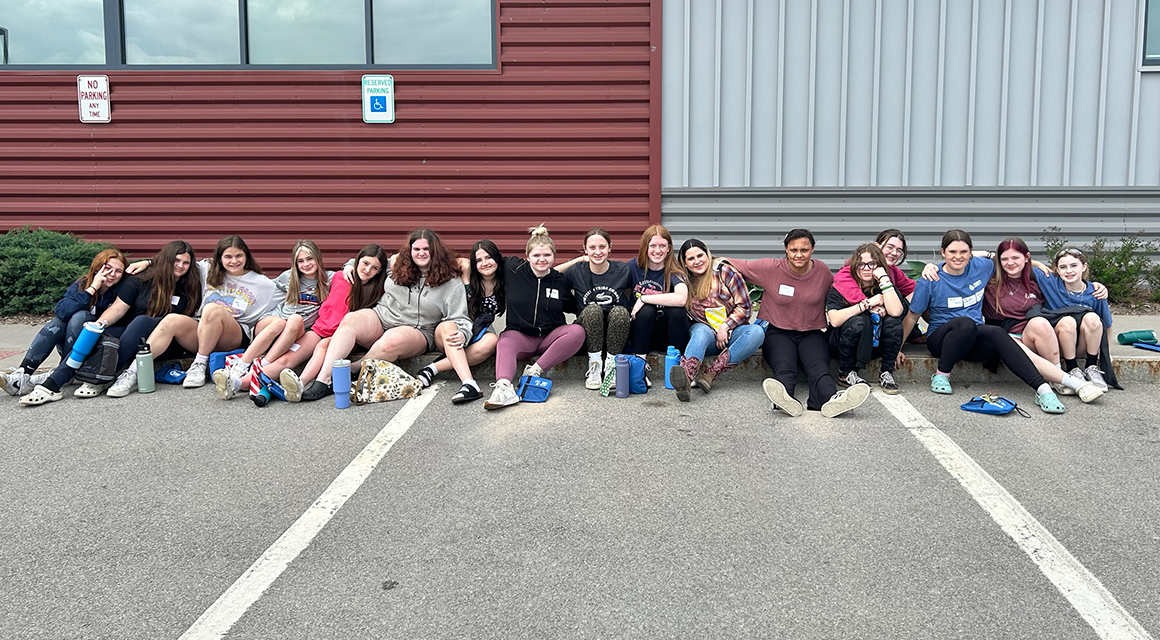 Liberty Partnerships students sit outside Nevaldine Hall after Women in Engineering Day.