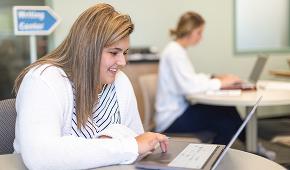 A student works on her laptop in the Learning Commons.