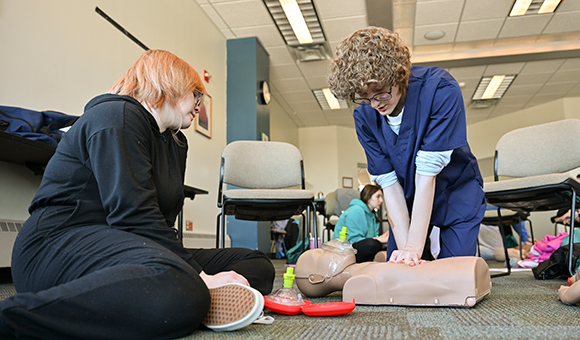 Two students practice CPR with the SUNY Canton EMS Squad.