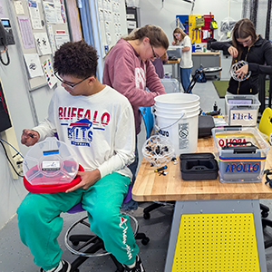 Madrid-Waddington students building and repairing drones in a technology classroom.