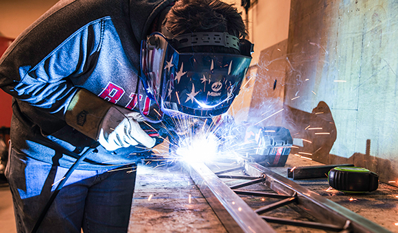 Mathew Greene welds a portion of the steel bridge.