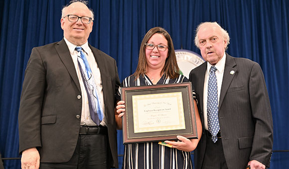 Morgan Showers is presented with the Excellence in Classified Service award from President Szafran and Chairman Ronald O'Neil.