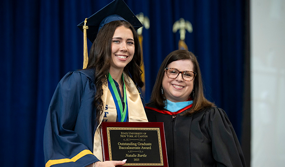 Natalie Bartle is presented with the Outstanding Graduate Award by Vice President Courtney Bish.