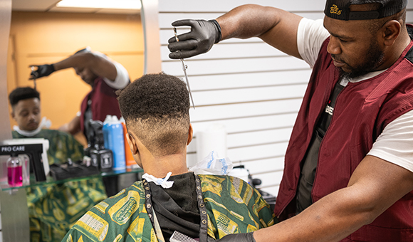 Yewkai Mujuru, gets a haircut from Master Barber Ron Fludd at Seasons Beauty Supply Store & Salon.