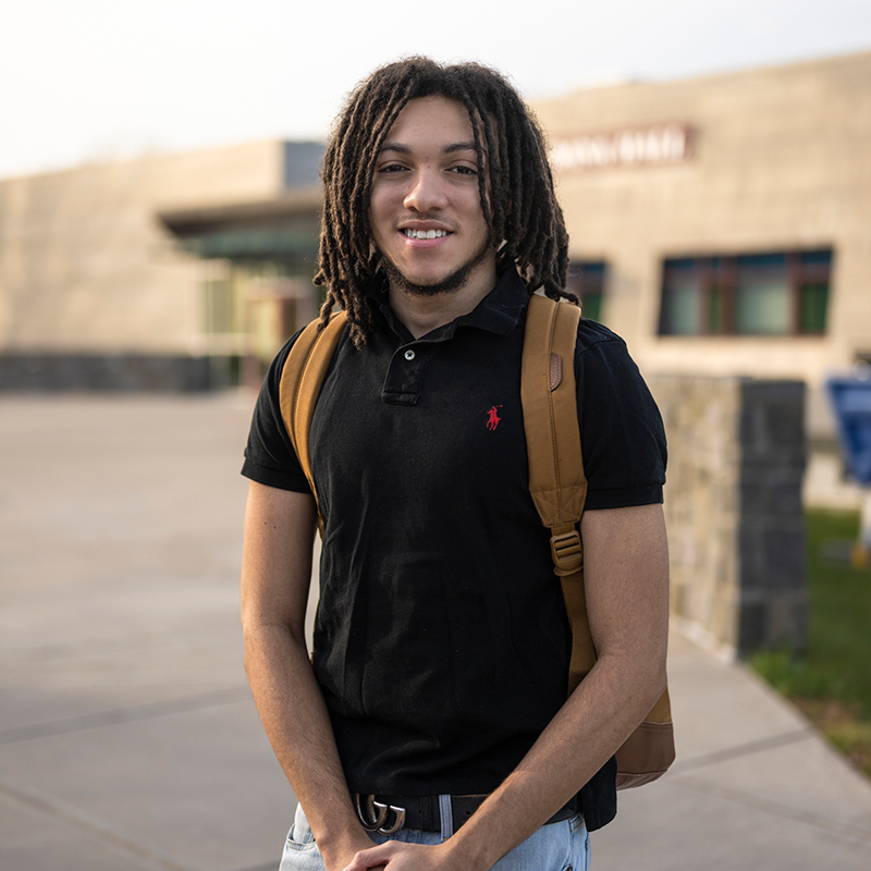 Taz Eggleston stands outside Dana Hall