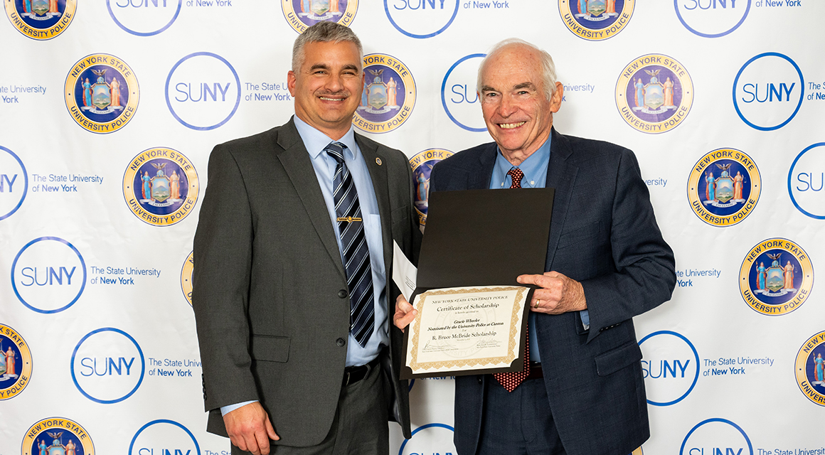 University Police Chief Tim Ashley accepts the McBridge Criminal Justice Award on behalf of Gracie Wheeler.