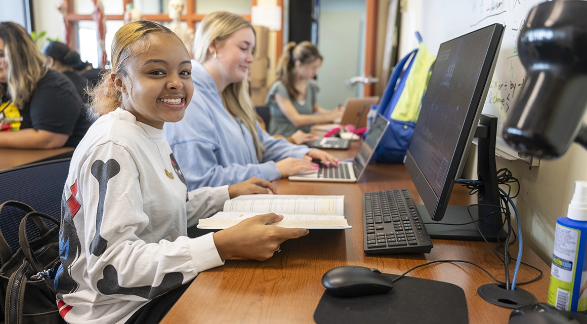 Students working on laptops in the tutoring lab..