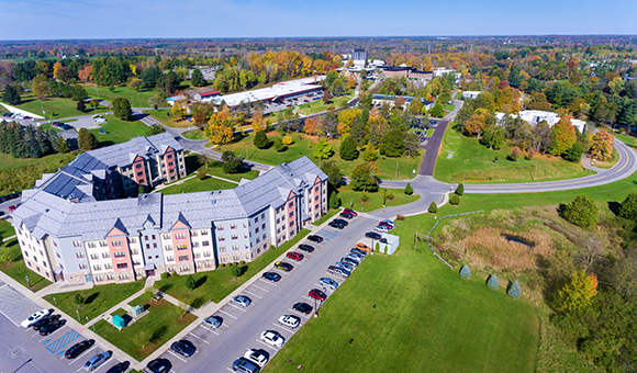 Aerial view of Kennedy Hall and campus during the beginning of autumn.