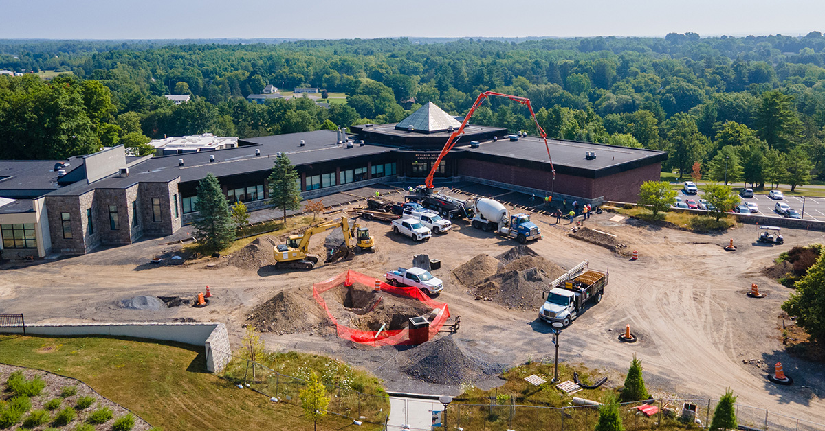 Aerial view of the campus center plaza construction. Crews work to add sidewalks to the outer perimeter.