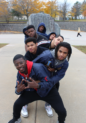 ATG Fraternity poses in front of the Campus Plaza rock.