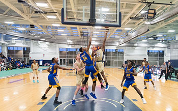 A SUNY Canton basketball player drives to the basket.