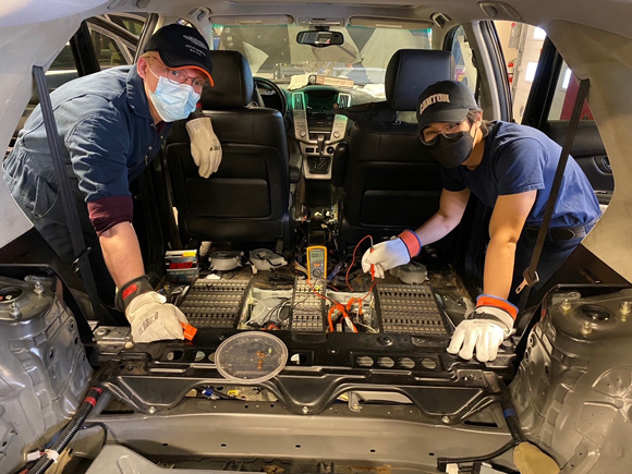 Students repair a hybrid vehicle.