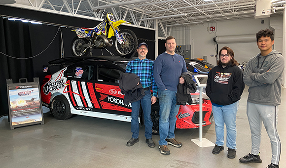 Brandon Baldwin with students at the Vermont Sports Car Show in 2023.