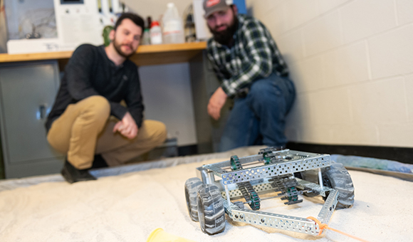 Owen Kuca and Patrick Taillon and their “Beach Roomba” device designed to help clean North Country beaches.