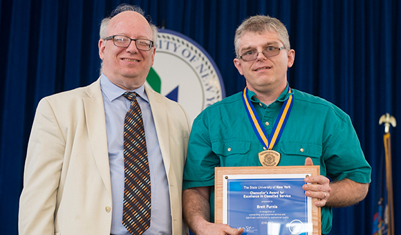 SUNY Canton president Zvi Szafran presents Brett M. Furnia with his Chancellor's Award