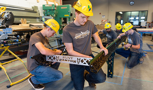 Steel bridge team assembles a championship bridge.