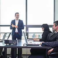 A person gives a presentation to a corporate board.