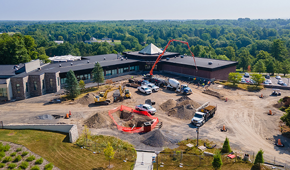 Crews pour concrete sidewalks adjacent to the Miller Campus Center as part of a plaza upgrade.