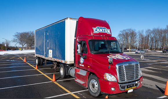 Side view of CDL truck with SUNY Canton graphics.