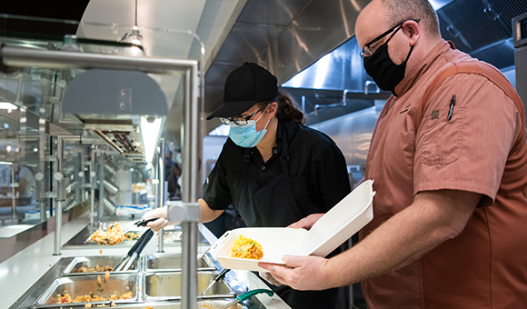 Chaney Dining Center staff prepare to-go containers.