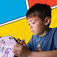 A camper draws on an iPad with a colorful comic book-style background.