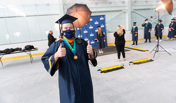 Joshua Godbout gives two thumbs up after getting his portrait taken.