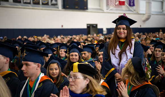 Danielle Giron Reyes stands to be recognized for the David R. Maynard Student Activities award.