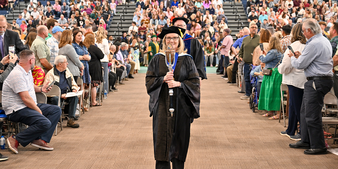 Professor Deborah Molnar carries the mace into SUNY Canton's 118th Commencement Ceremony.